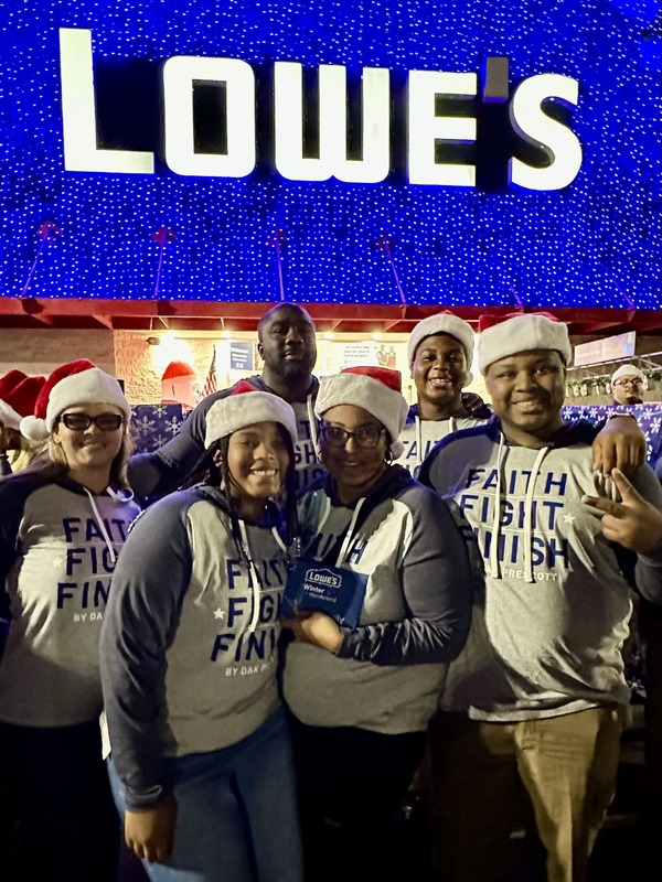 People posing happily in front of lowes
