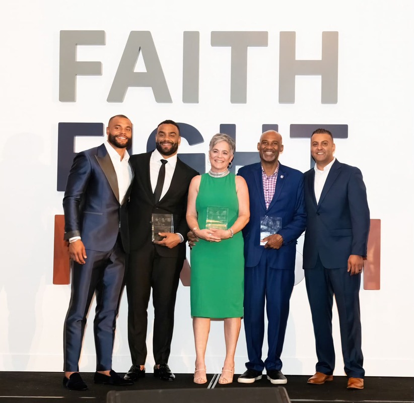 group people posing for photo with faith fight finish logo in background
