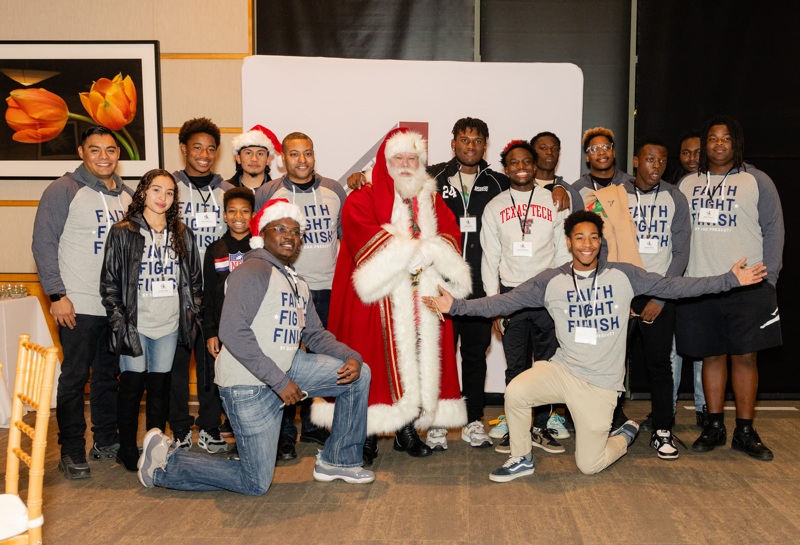 group of people posing for christmas photo with santa claus